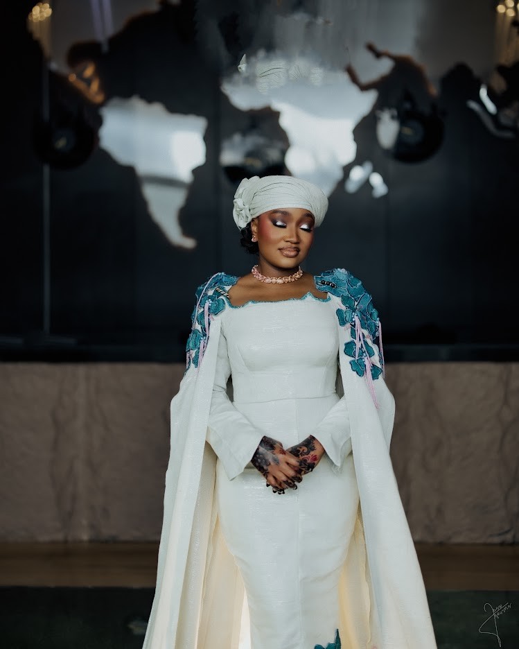 Bridal portrait in white attire with turquoise floral details and a white headwrap