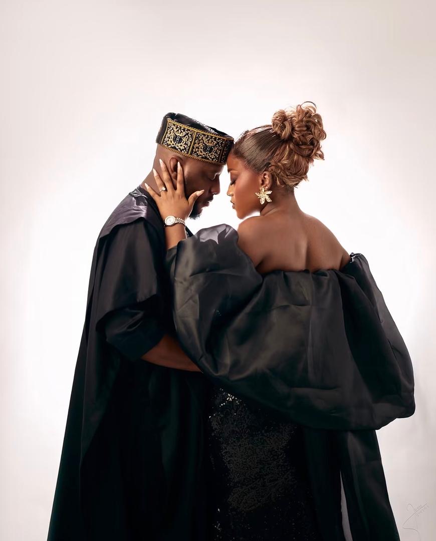 Couple touching foreheads in elegant black attire