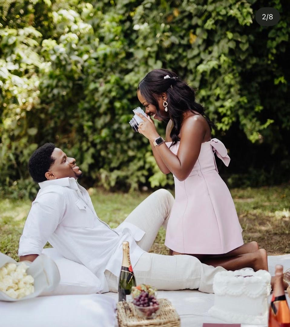 Couple sharing a joyful moment at a garden picnic