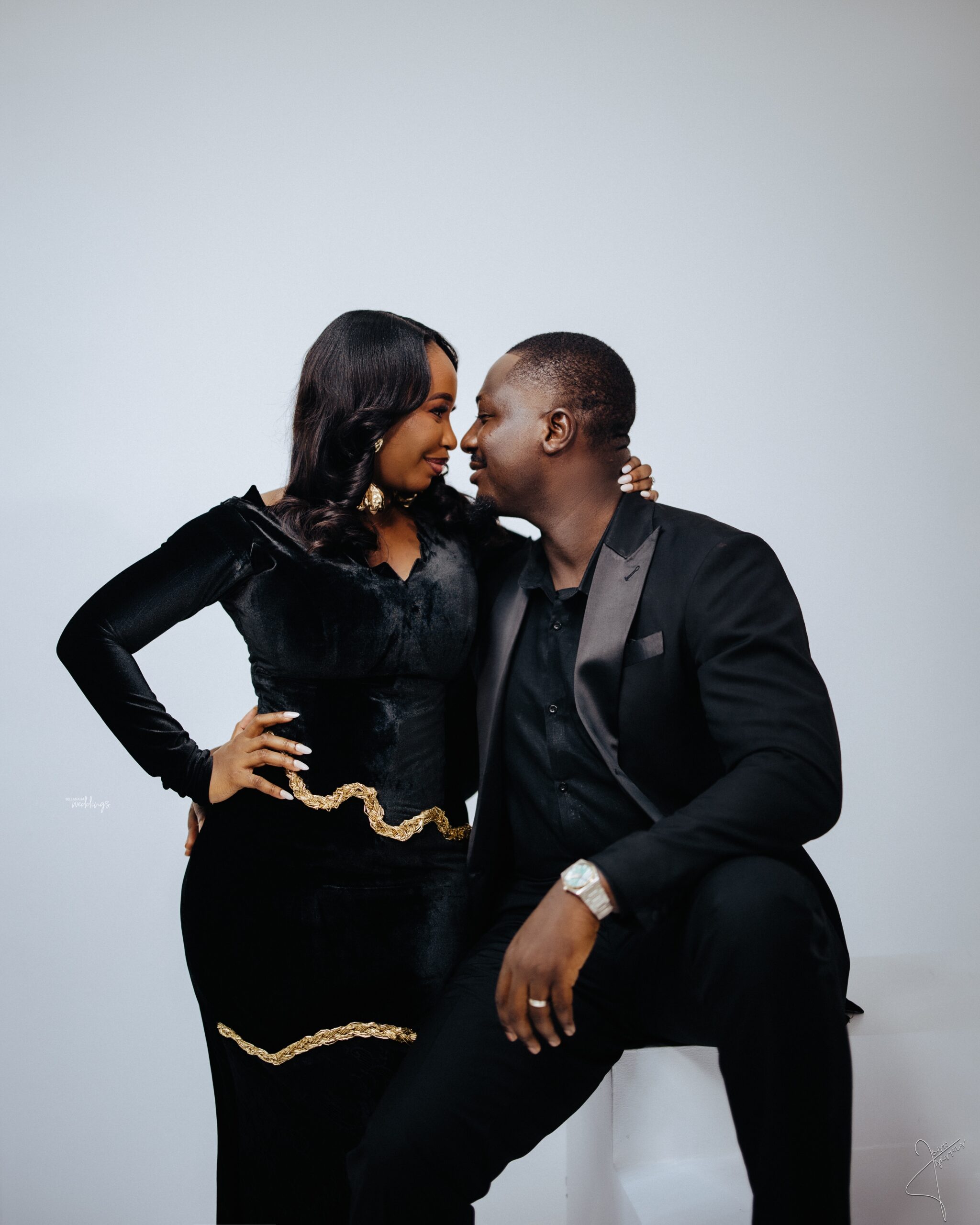 Tunmise and Haleem leaning toward one another in a studio portrait