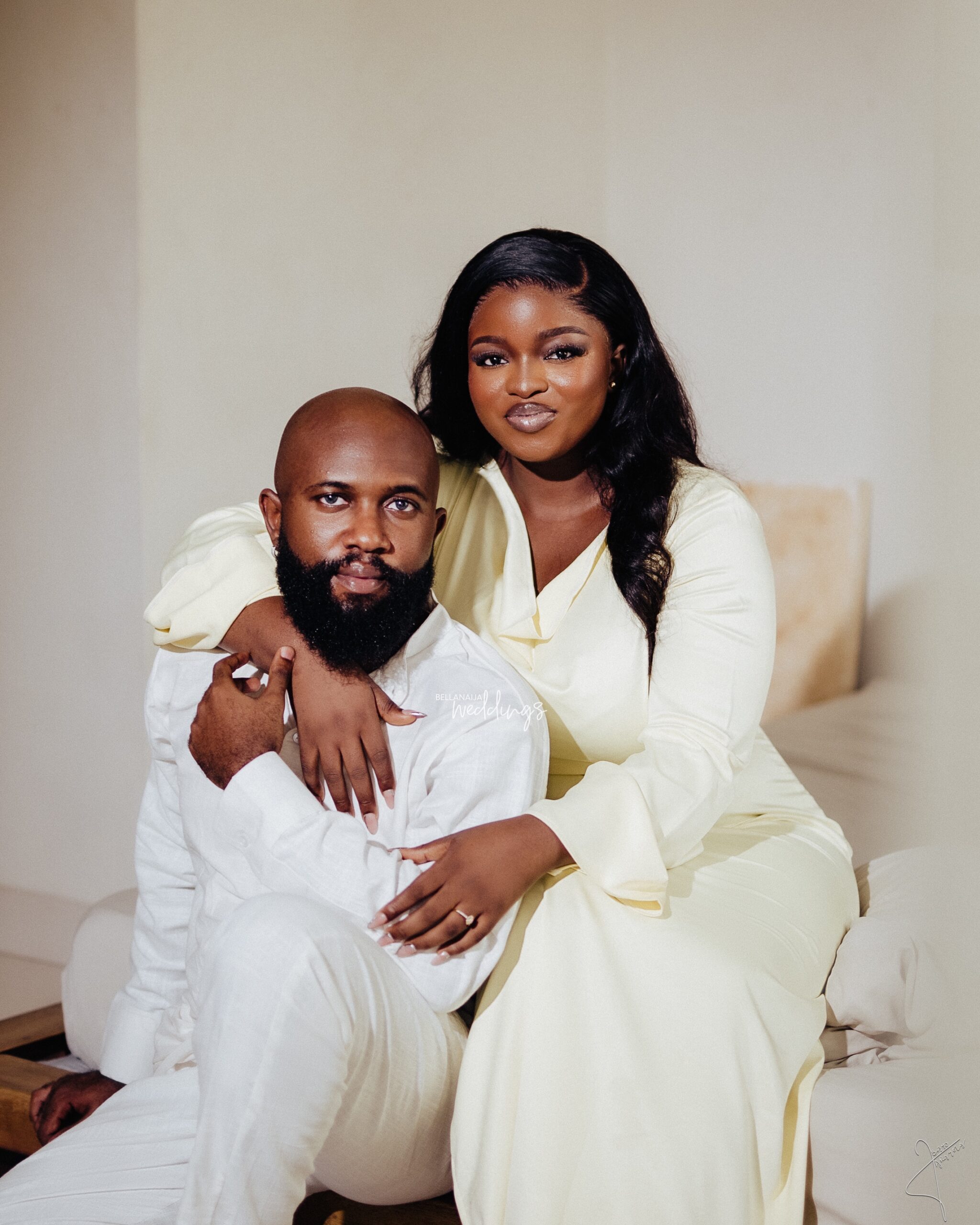 Tolulope and Martins posing together in coordinated ivory outfits