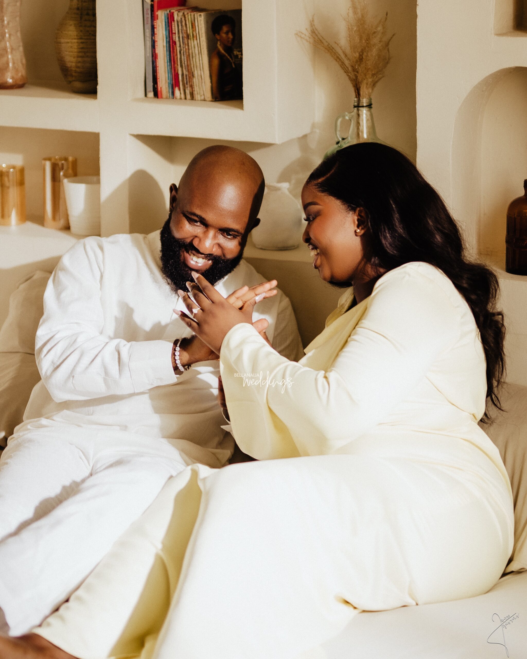 Tolulope and Martins laughing together in soft ivory outfits