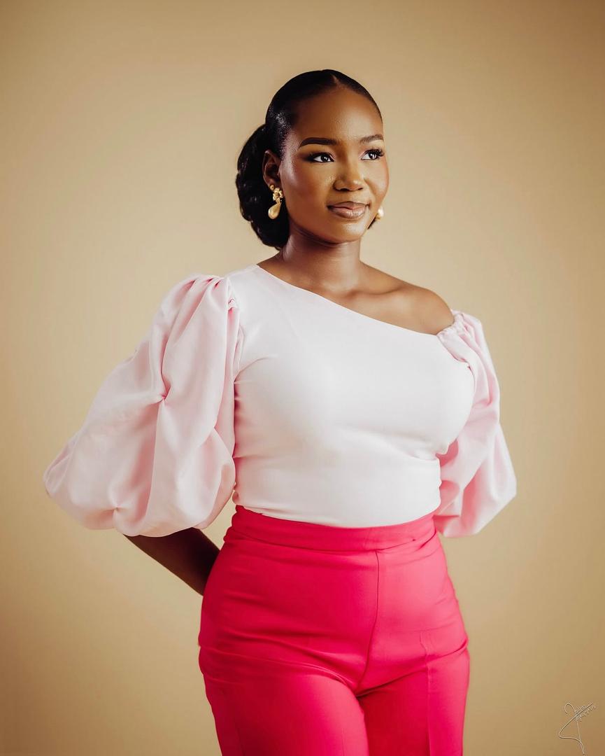 Woman in a pink blouse and bright pink trousers