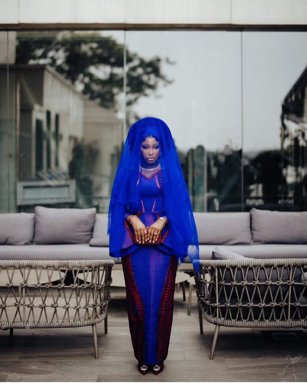 Bride in royal blue traditional attire and a sheer veil