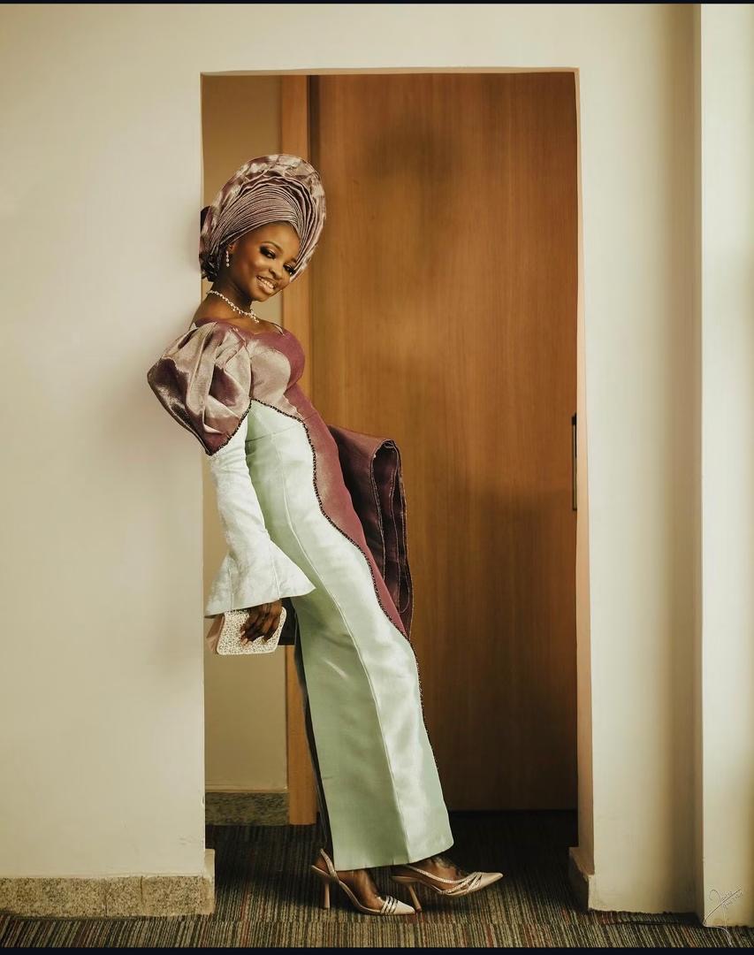 Bride in a sculpted traditional outfit posing in a doorway