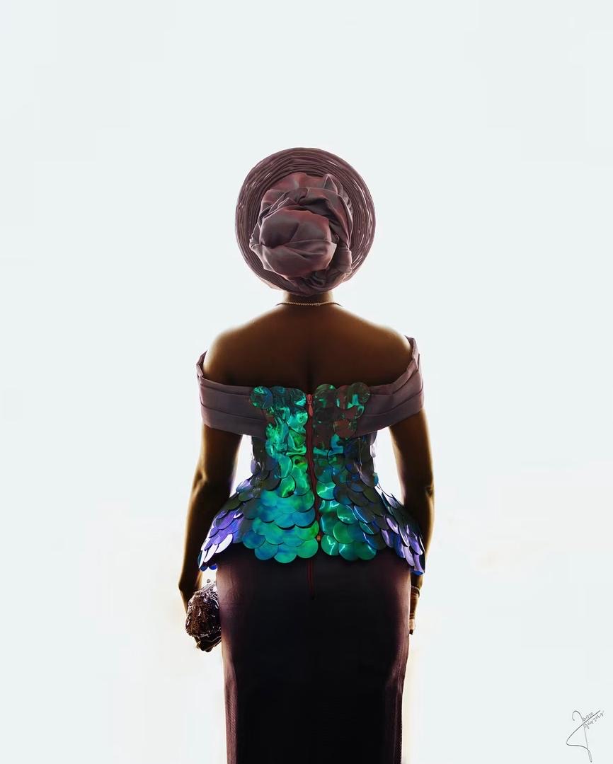 Bride viewed from behind in an iridescent traditional outfit and headwrap