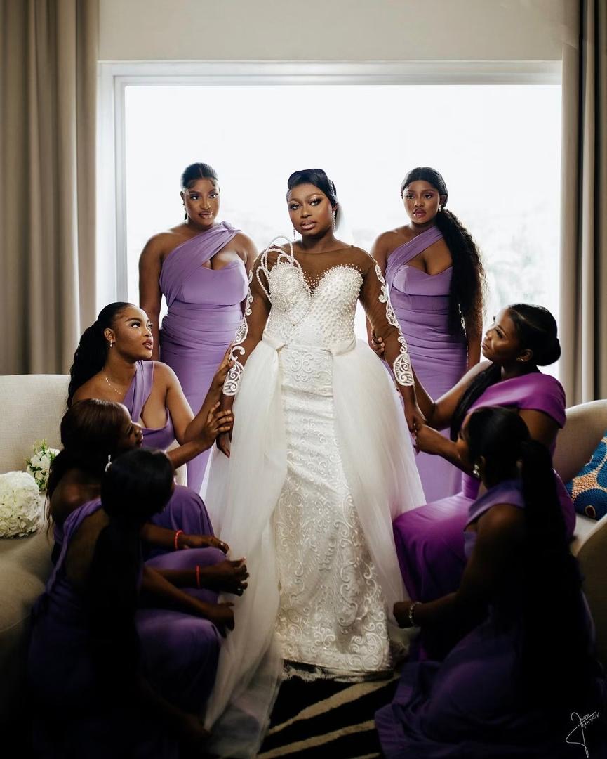 Bride surrounded by bridesmaids in purple dresses