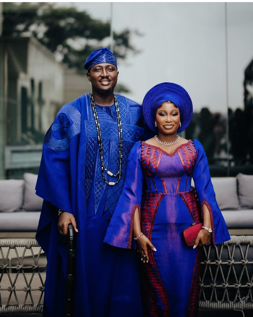 Newlyweds posing in coordinated royal blue traditional attire