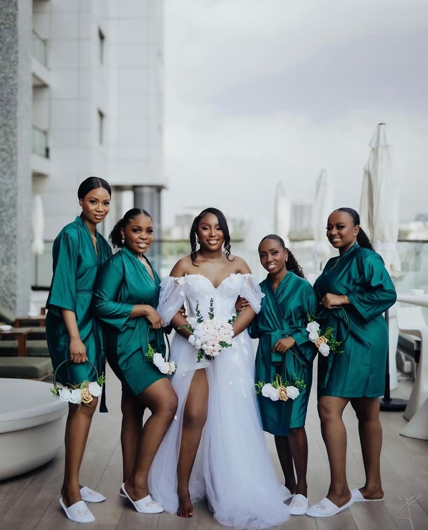 Bride with bridesmaids wearing teal robes